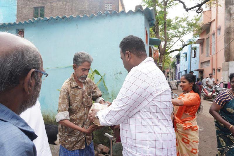 Distributing 5 kg rice bags to specially-abled res