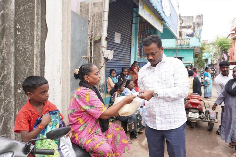 Distributing 5 kg rice bags to specially-abled res