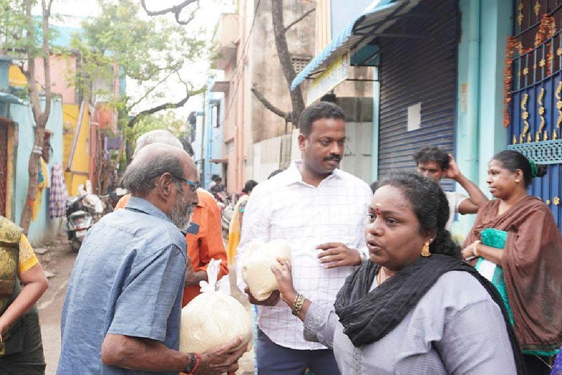 Distributing 5 kg rice bags to specially-abled res