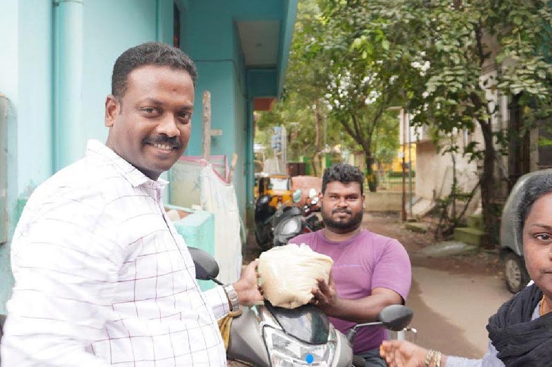 Distributing 5 kg rice bags to specially-abled res